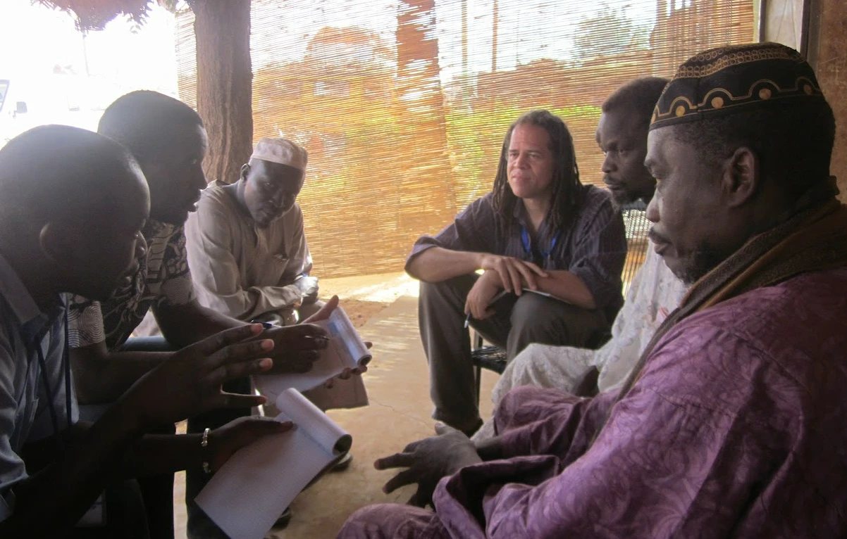 Our team in discussion with community elders, taking notes