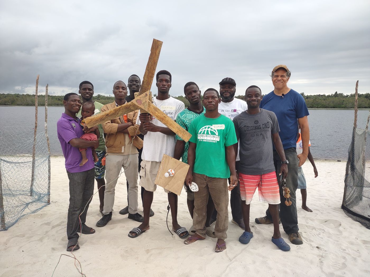 A group standing by the water with model wind turbines ready for testing