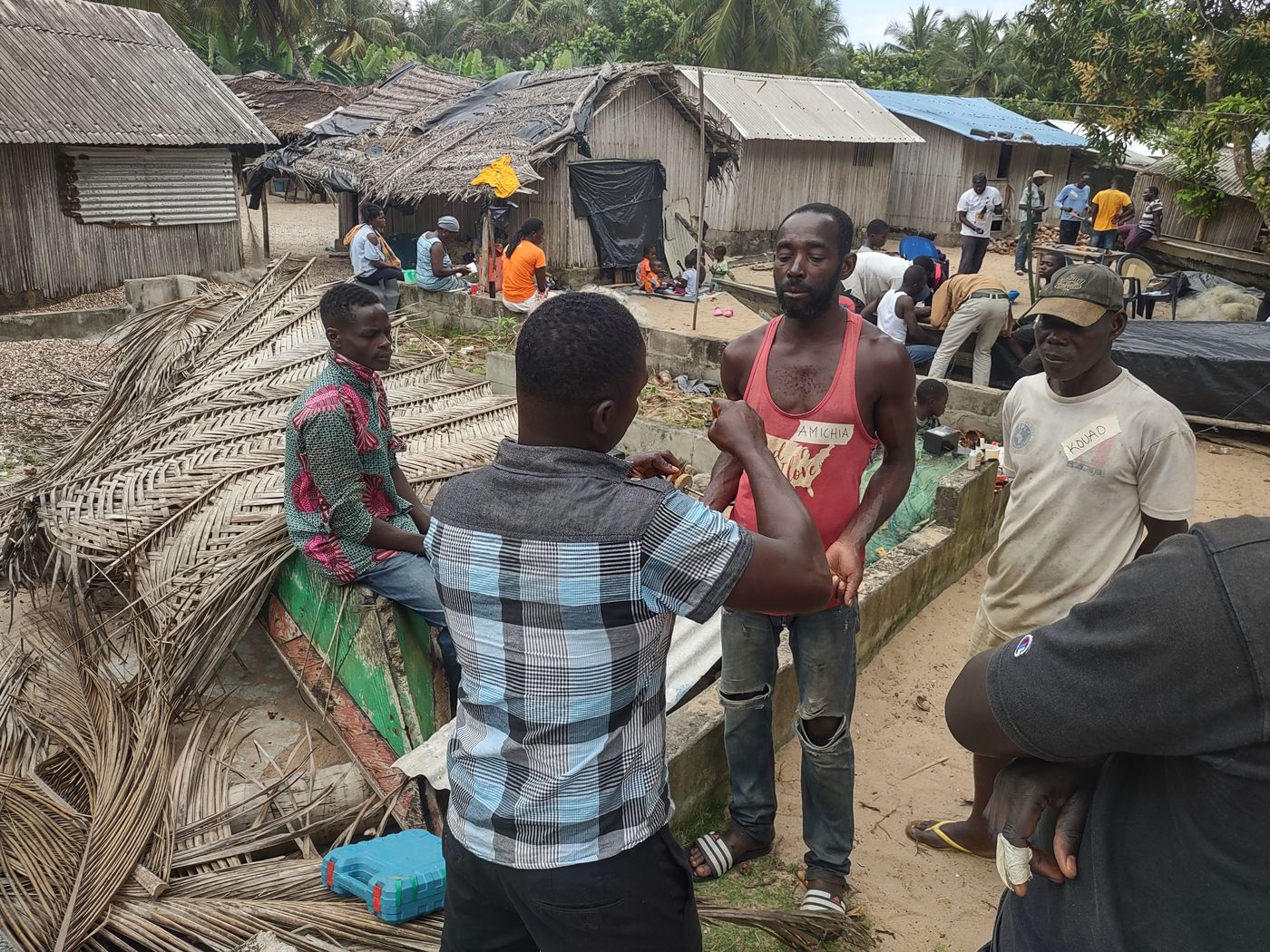Community members assembling turbine parts in a village